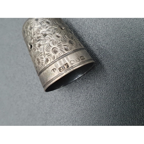 85 - A Victorian silver Thimble with rosette design, A/F, two other Thimbles, a sterling Whistle in the f... 