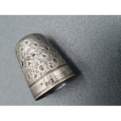 85 - A Victorian silver Thimble with rosette design, A/F, two other Thimbles, a sterling Whistle in the f... 