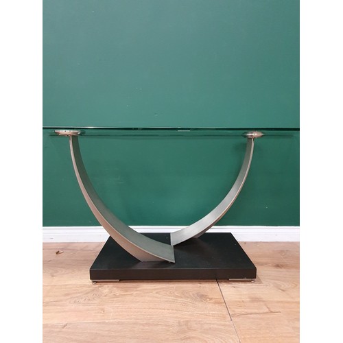 565A - A Modern Glass Console table with rectangular top on shaped supports and ebonised rectangular base, ... 