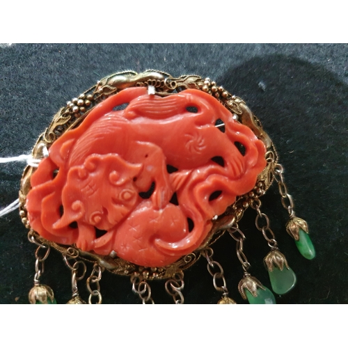 170 - A Coral bead Necklace and a Coral Brooch with carved dragon in gilt metal frame suspending polished ... 