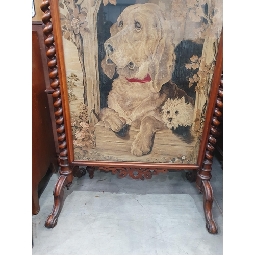 40 - A Victorian walnut framed Firescreen with needlework of a hound beneath fretwork frieze and flanked ... 