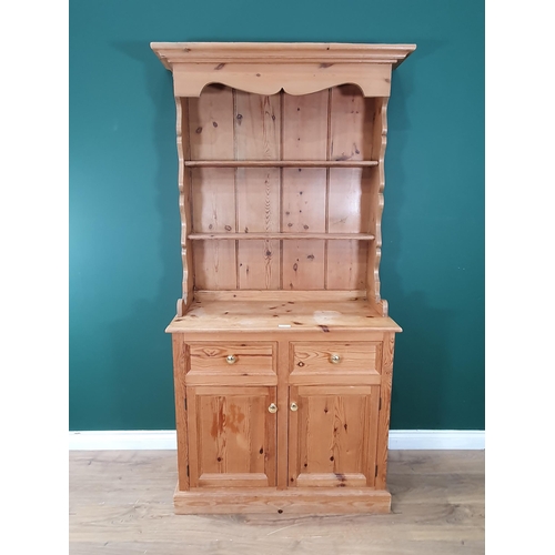 538A - A small pine Dresser and Rack, the base fitted two drawers and a pair of cupboard doors, 6ft 2in H x... 