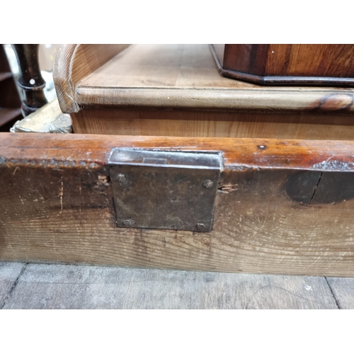 581 - A painted industrial Artists Table/Bench on square supports and stretchers and large metal castors, ... 