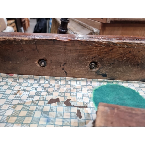 581 - A painted industrial Artists Table/Bench on square supports and stretchers and large metal castors, ... 