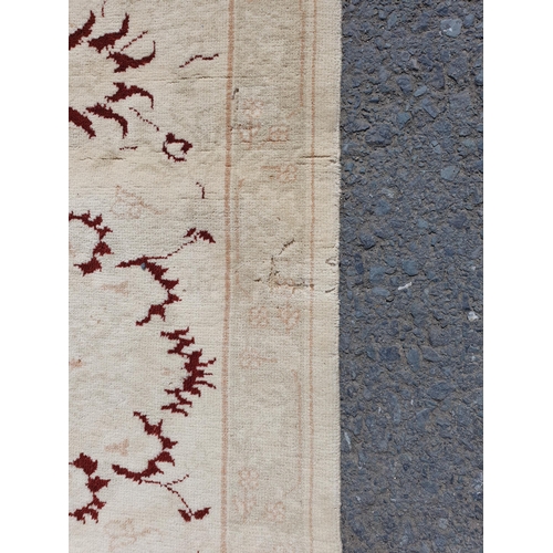 1 - An Ushak style wool Carpet the beige and maroon sylised floral design on cream ground, 10ft x 14ft, ... 