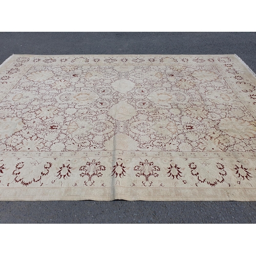 1 - An Ushak style wool Carpet the beige and maroon sylised floral design on cream ground, 10ft x 14ft, ... 