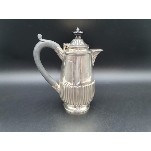 124 - A Victorian silver Hot Water Jug of semi-fluted form with ebonised handle, London 1881, 360gms all i... 