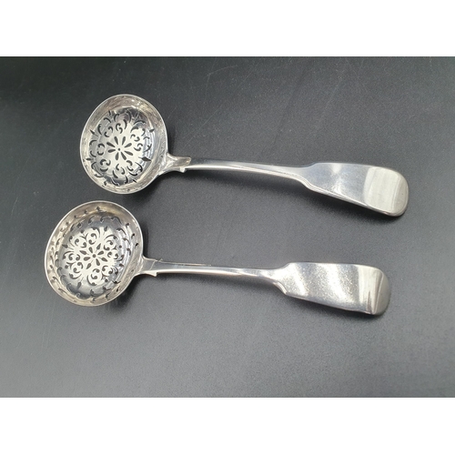 131 - A George IV silver Sifting Ladle, fiddle pattern, London 1825, and another similar, Exeter 1855