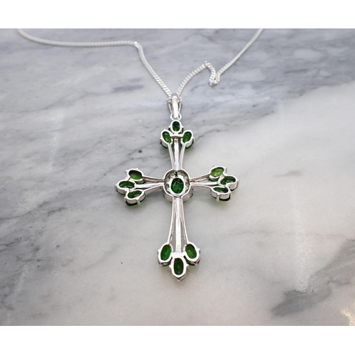 155 - A gem-set Kielder Cross claw-set thirteen oval-cut diopside and round tsavorite in silver on fine ch... 