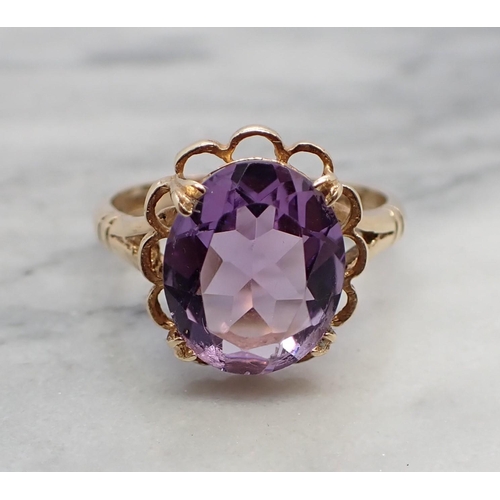 163 - An Amethyst Dress Ring claw-set oval-cut stone in 9ct gold, ring size N 1/2