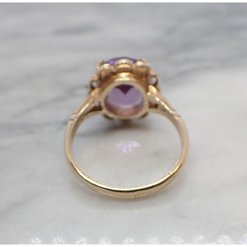 163 - An Amethyst Dress Ring claw-set oval-cut stone in 9ct gold, ring size N 1/2