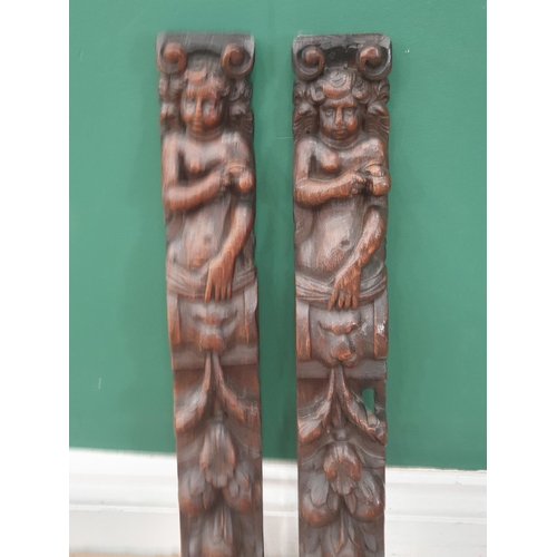 24 - A pair of 17th Century oak Caryatids with carved figures and lion masks above fruiting vines, 1ft 9