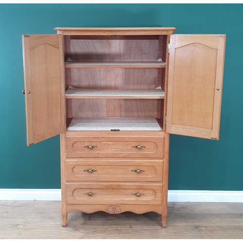 25 - A modern oak Press Cupboard fitted pair of fielded doors above three drawers 4ft 11in H x 2ft 9in W ... 