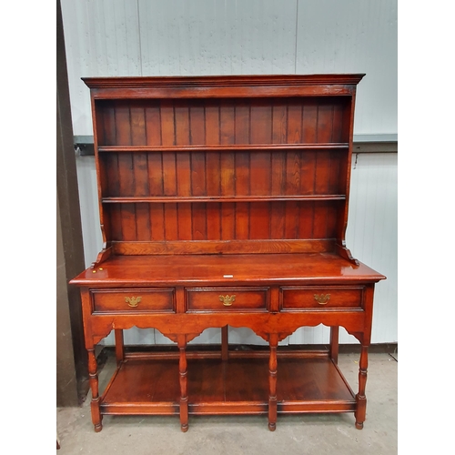 26 - A reproduction stanley crumper oak Potboard Dresser and Rack, the base fitted three drawers raised o... 