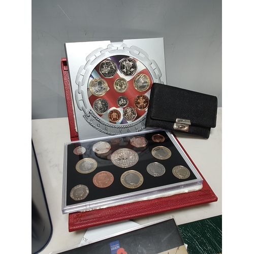 269 - A tin of collector's Coins, to include 2007 Royal Mint proof set, 2006 UNC Pack, 
a part set of US s... 