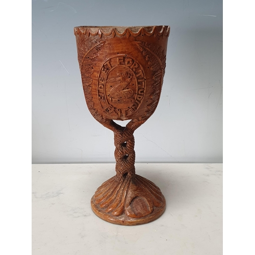 295 - A sycamore Goblet with carved crests and leafage design 9in H (woodworm) (R7)