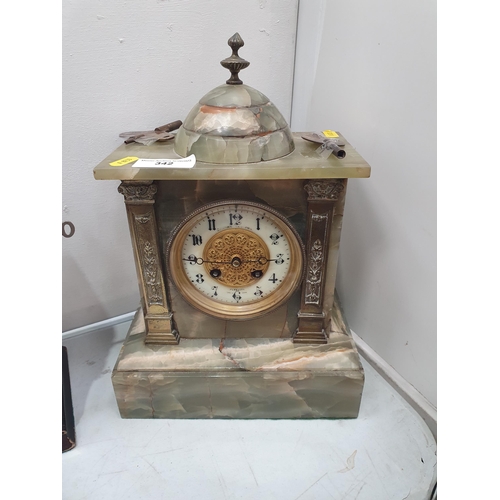 342 - An Onyx and brass decorated Mantel Clock and a three Bottle Tantalus. (R5).