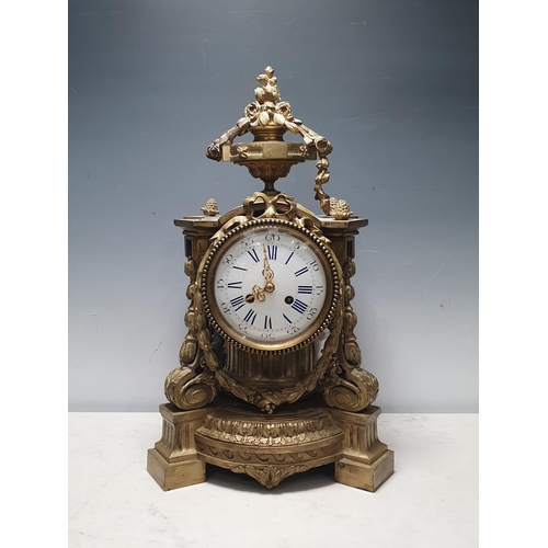 40 - A French Gilt Mantel Clock with urn and floral swag pediment, with four scrolled a leafage uprights,... 