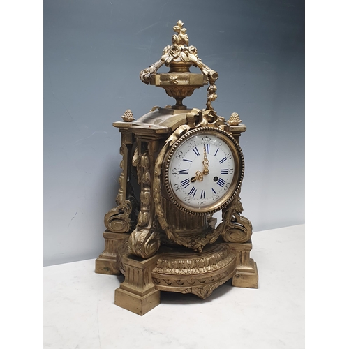 40 - A French Gilt Mantel Clock with urn and floral swag pediment, with four scrolled a leafage uprights,... 