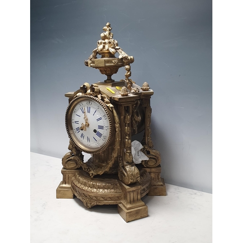 40 - A French Gilt Mantel Clock with urn and floral swag pediment, with four scrolled a leafage uprights,... 