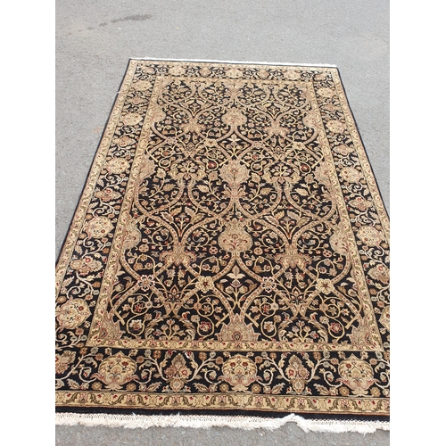 41 - A black ground Rug with trailing gold floral design 9ft 4in L x 6ft W