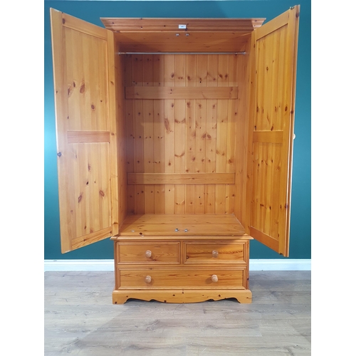 475 - A modern pine two section Wardrobe, the base fitted with two short and one long drawer, 6ft 4