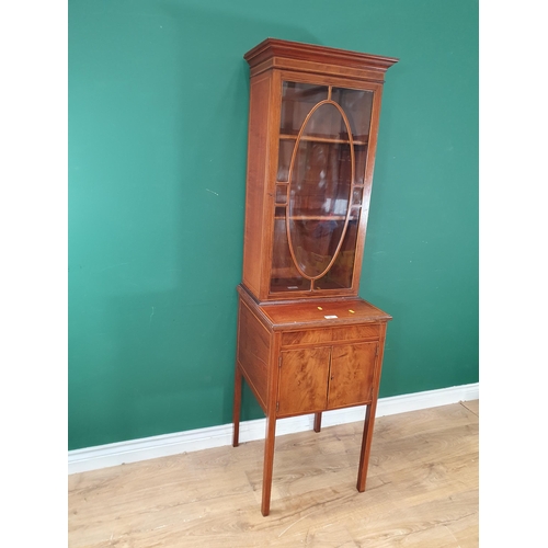 481 - A mahogany Glazed Cabinet with satinwood stringing, the single door enclosing two adjustable shelves... 