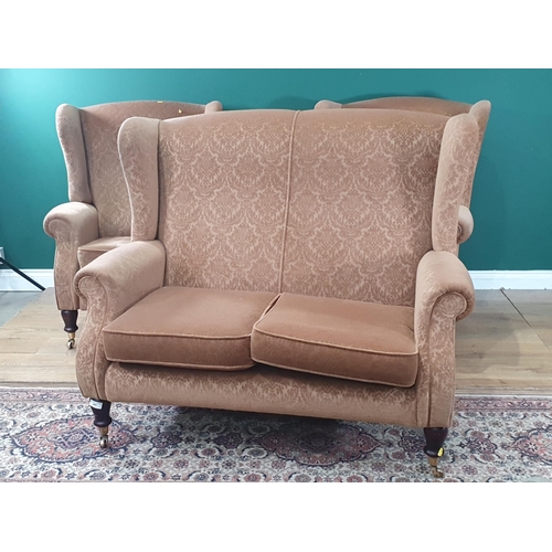 495 - A Parker Knoll brown upholstered wing back three piece suite, sofa 4ft W x 3ft 2in H, chairs 2ft 6in... 