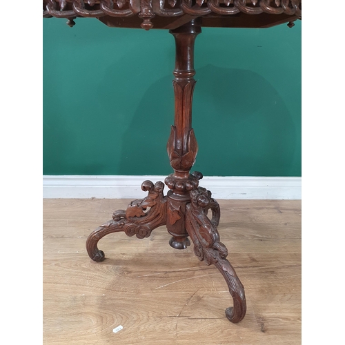 505 - A Victorian walnut Occasional Table with designs of Ibex and Deer to top mounted upon leafage carved... 