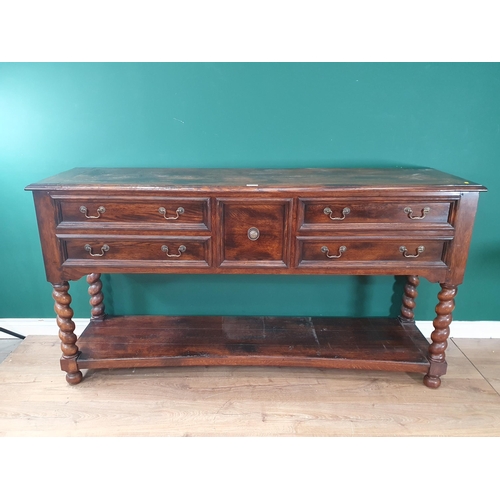 523 - A large modern oak Sideboard fitted five Drawers with open tier underneath raised on twisted support... 