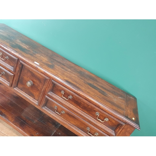 523 - A large modern oak Sideboard fitted five Drawers with open tier underneath raised on twisted support... 