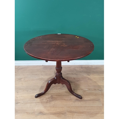 563 - An antique oak Pillar Table with circular top, on vase turned column and tripod base, 2ft 8