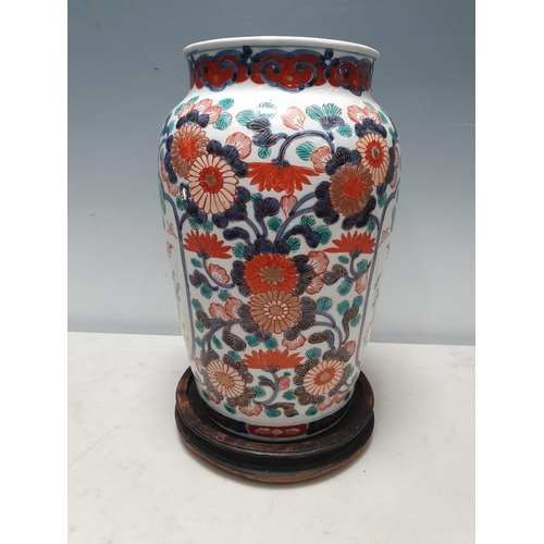 57 - A 19th Century Imari baluster Vase painted figures in shaped reserves flowering shrub surround in re... 