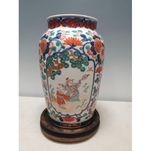 57 - A 19th Century Imari baluster Vase painted figures in shaped reserves flowering shrub surround in re... 