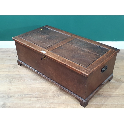 596 - An antique oak Blanket Box with panelled lid, pair of carry handles and raised on bracket feet, 13