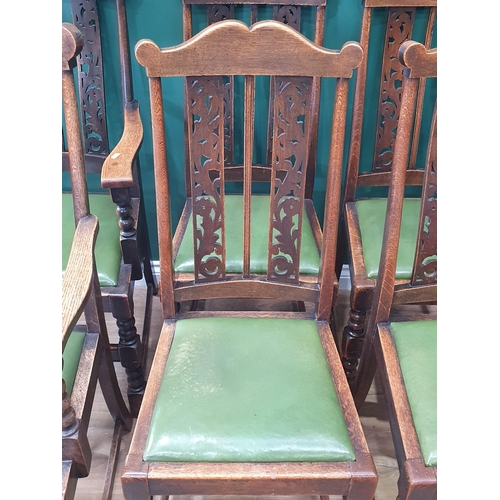 602 - A set of six oak framed Dining Chairs with pierced carved backrests, green upholstered drop in seats... 