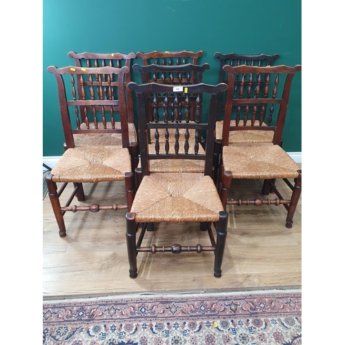 609 - A set of seven Spindle back rush seated Chairs on turned supports and stretchers. (R9).