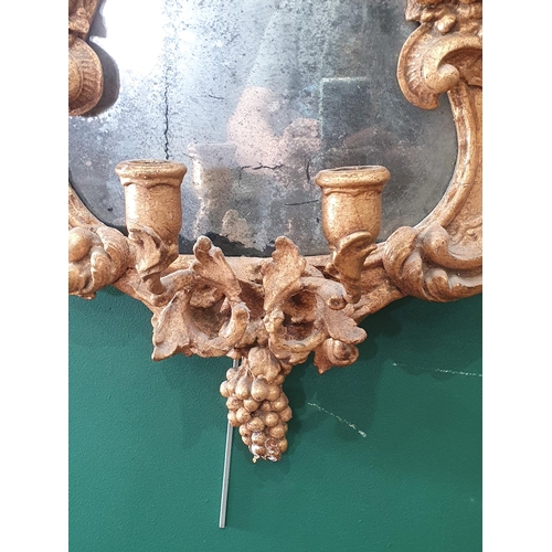 610 - A Rococo style gilded Wall Mirror with two branch candle sconce 2ft 5in H x 1ft 5in W