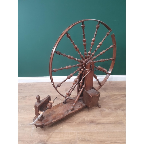 614 - A Vintage walnut Spinning Wheel on oval base on turned supports A/F. (BW).