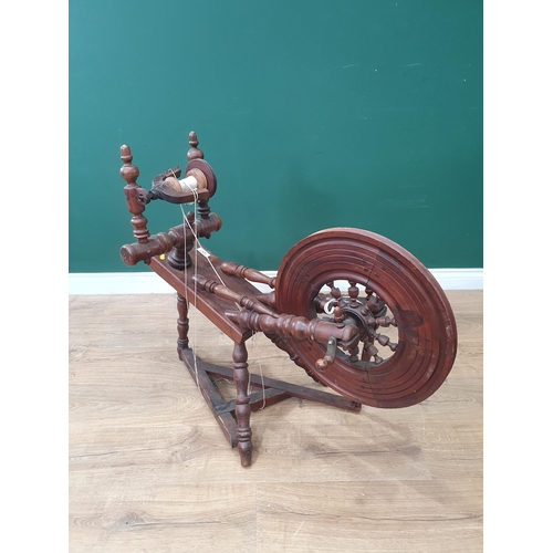 616 - A Vintage Spinning Wheel on turned supports. (R9).