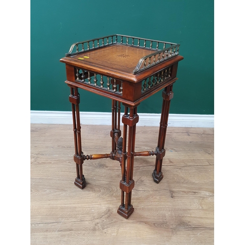 630 - A reproduction walnut Lamp Table with raised gallery, inset leather style top above column frieze, r... 