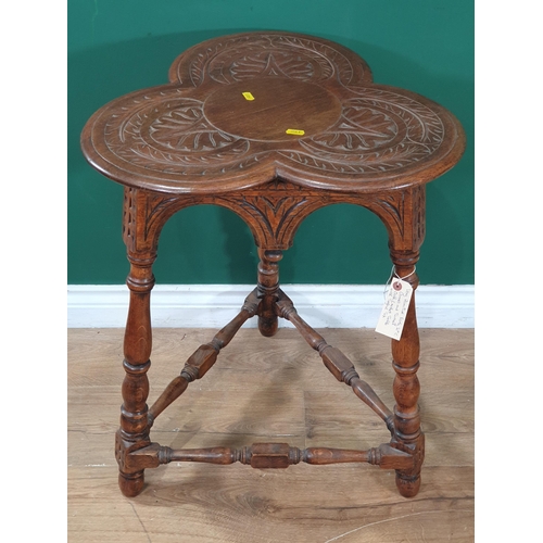 646 - A 20th Century oak Trefoil top Occasional Table with carved decorations above carved and shaped frie... 