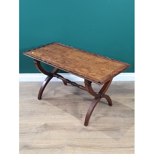 647 - A walnut veneered Coffee Table on X frame supports united by turned central stretcher, 1ft 8