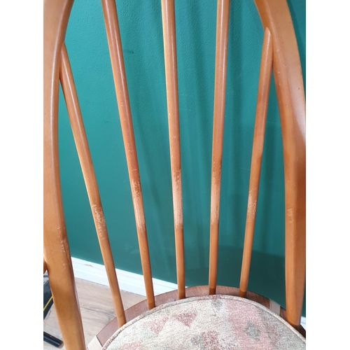 673 - An Ercol Dining Table and six stick back Chairs (R6)