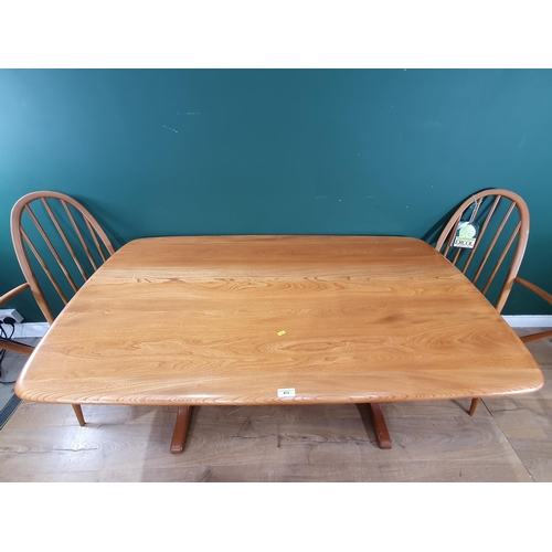 673 - An Ercol Dining Table and six stick back Chairs (R6)