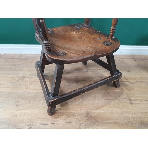 679 - A 19th Century ash and elm bar-back Elbow Chair on primitive supports united by surrounding stretche... 