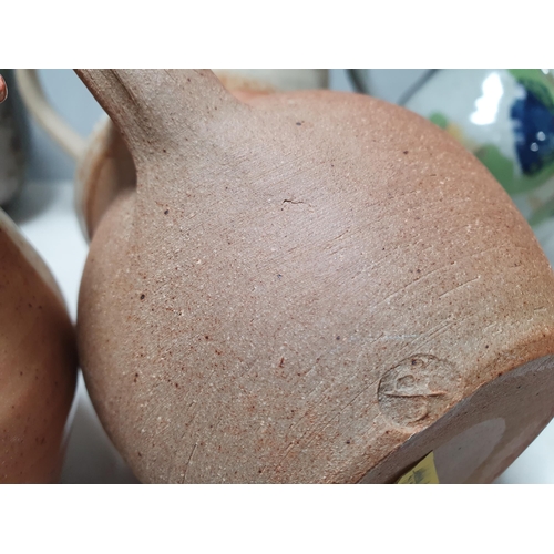 70 - Ten various studio pottery/stoneware Jugs with various designs & glazes, one incised Clive, some imp... 