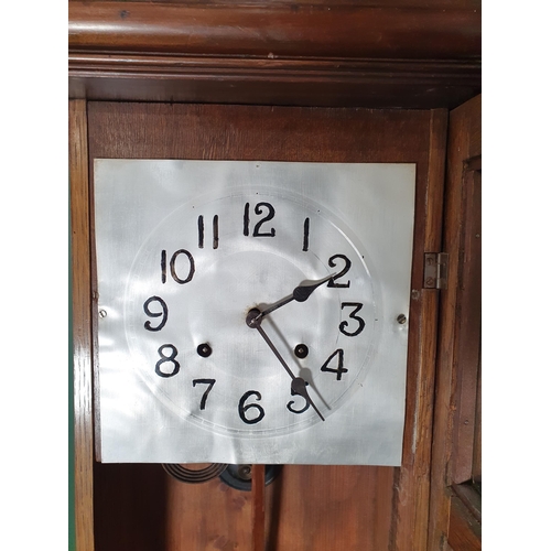 704 - An oak cased Wall Clock with carved floral pediment, 3ft High x 14