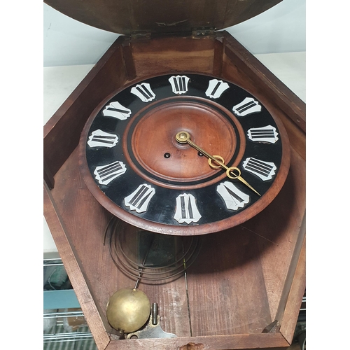 723 - A mahogany and ebonised oval cased Wall Clock with stylised motif patterns, 2ft 4in H x 1ft 11in W. ... 