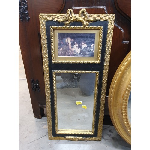 385 - An octagonal wall mirror, gilt framed oval mirror and gilt frames mirror with paiting to the top